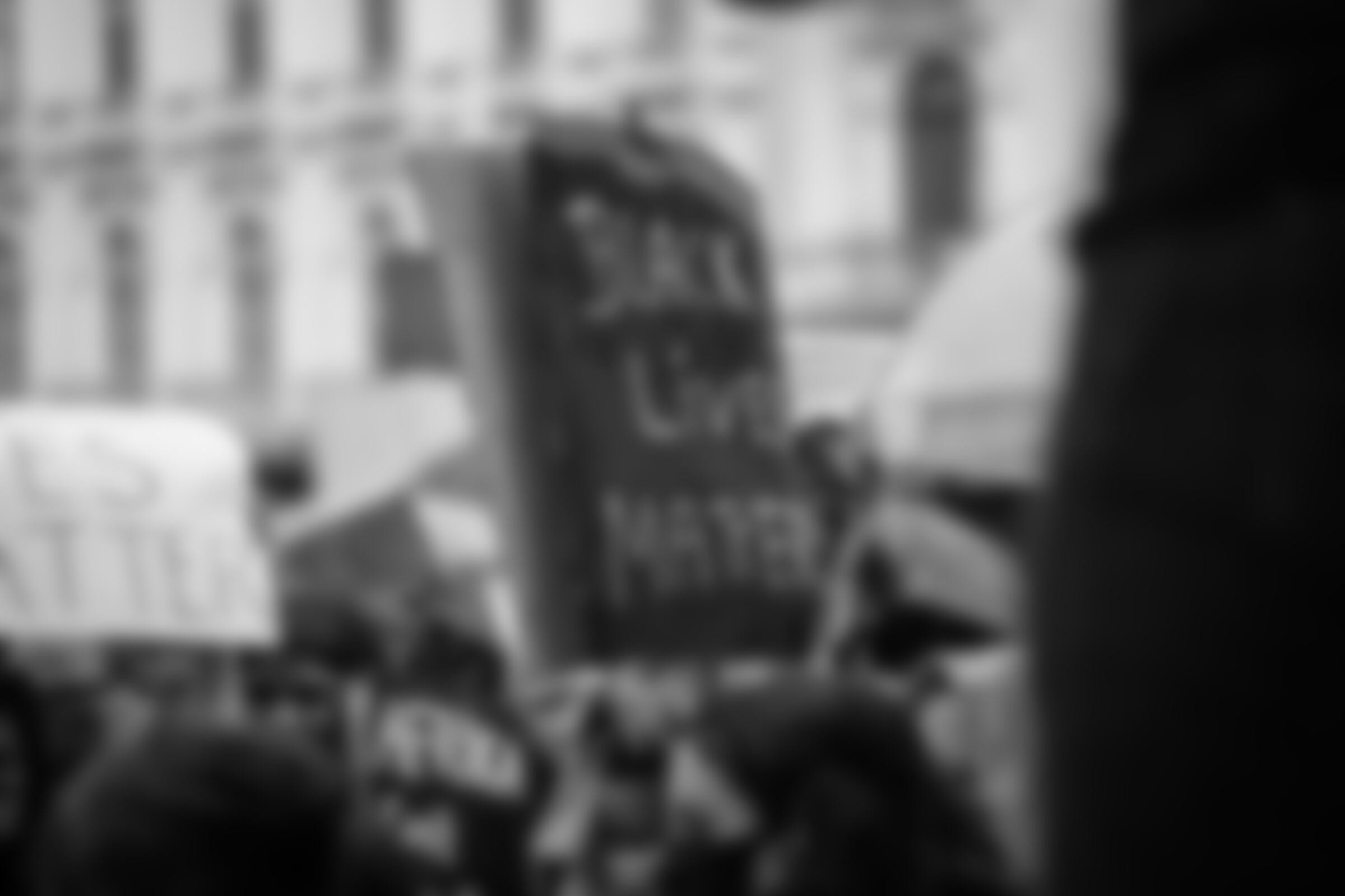 Unrecognizable activists with Black Lives Matter title on placard